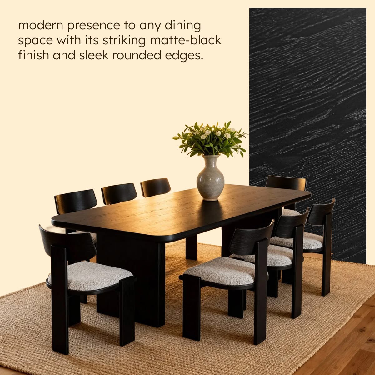 Dining table set with chairs and a vase of flowers against a textured wall.