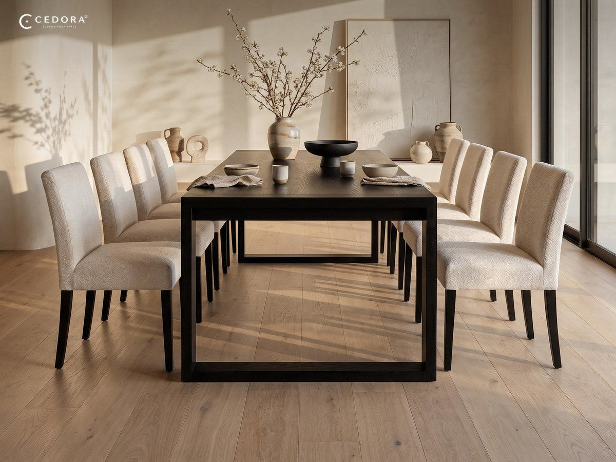Richmond dining table in black with pale upholstered chairs in a sunlit room with curved plaster ceiling and oak floors