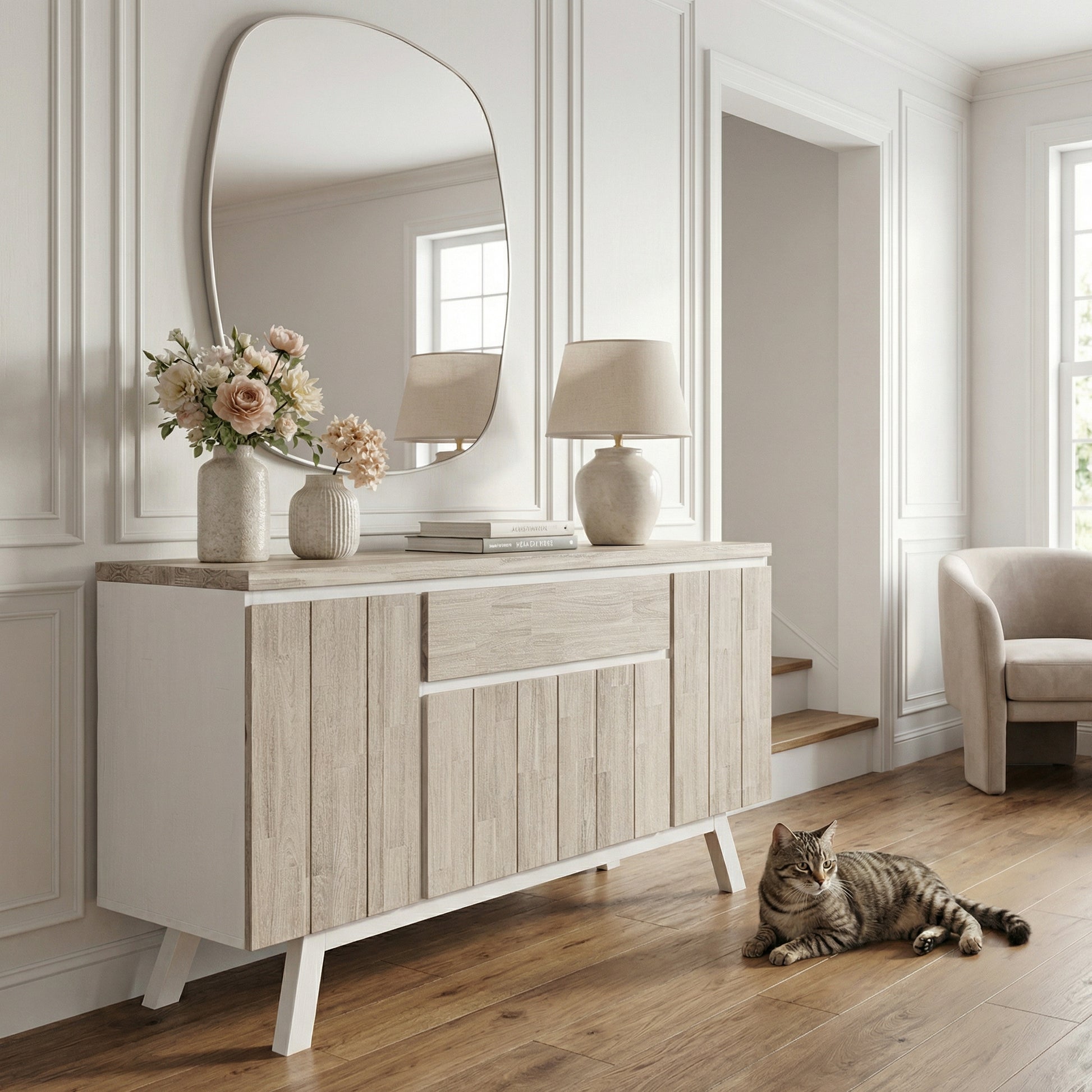 Light wood sideboard with decorative items in a room with a cat sitting on the floor.

