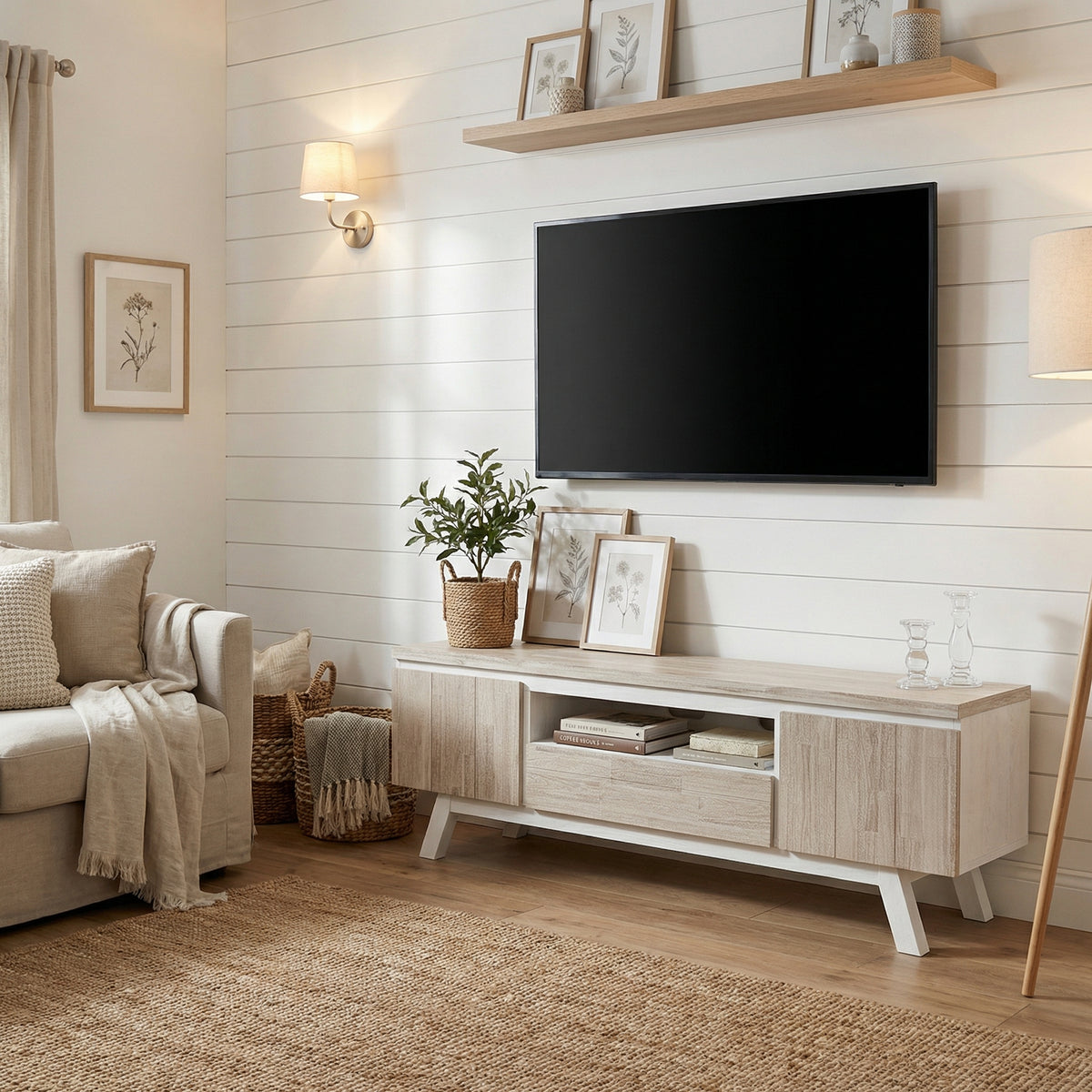 Living room with a TV mounted on the wall, wooden cabinet, and decorative items.

