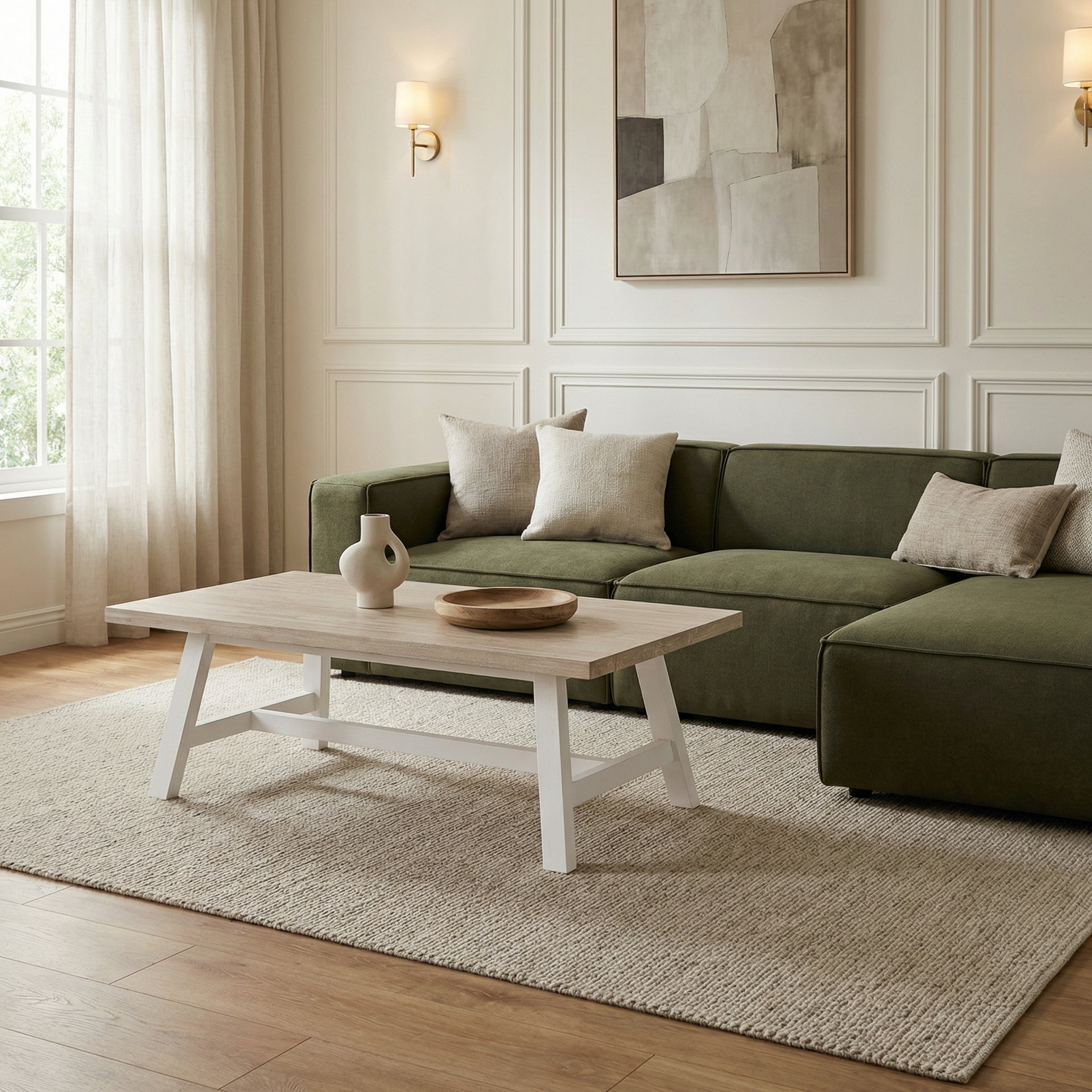Modern living room with a green sofa, wooden coffee table, and abstract art on the wall.

