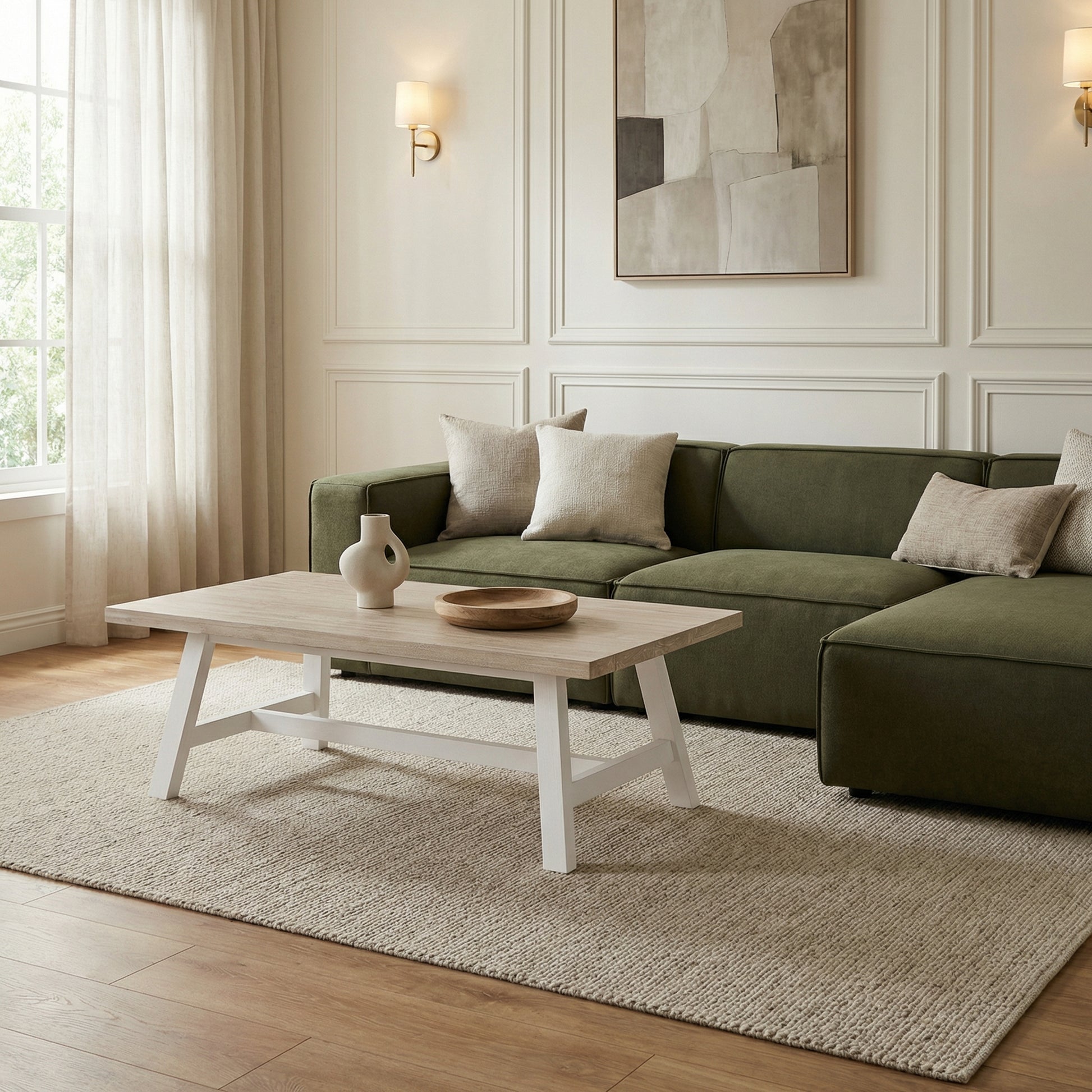 Modern living room with a green sofa, wooden coffee table, and abstract art on the wall.

