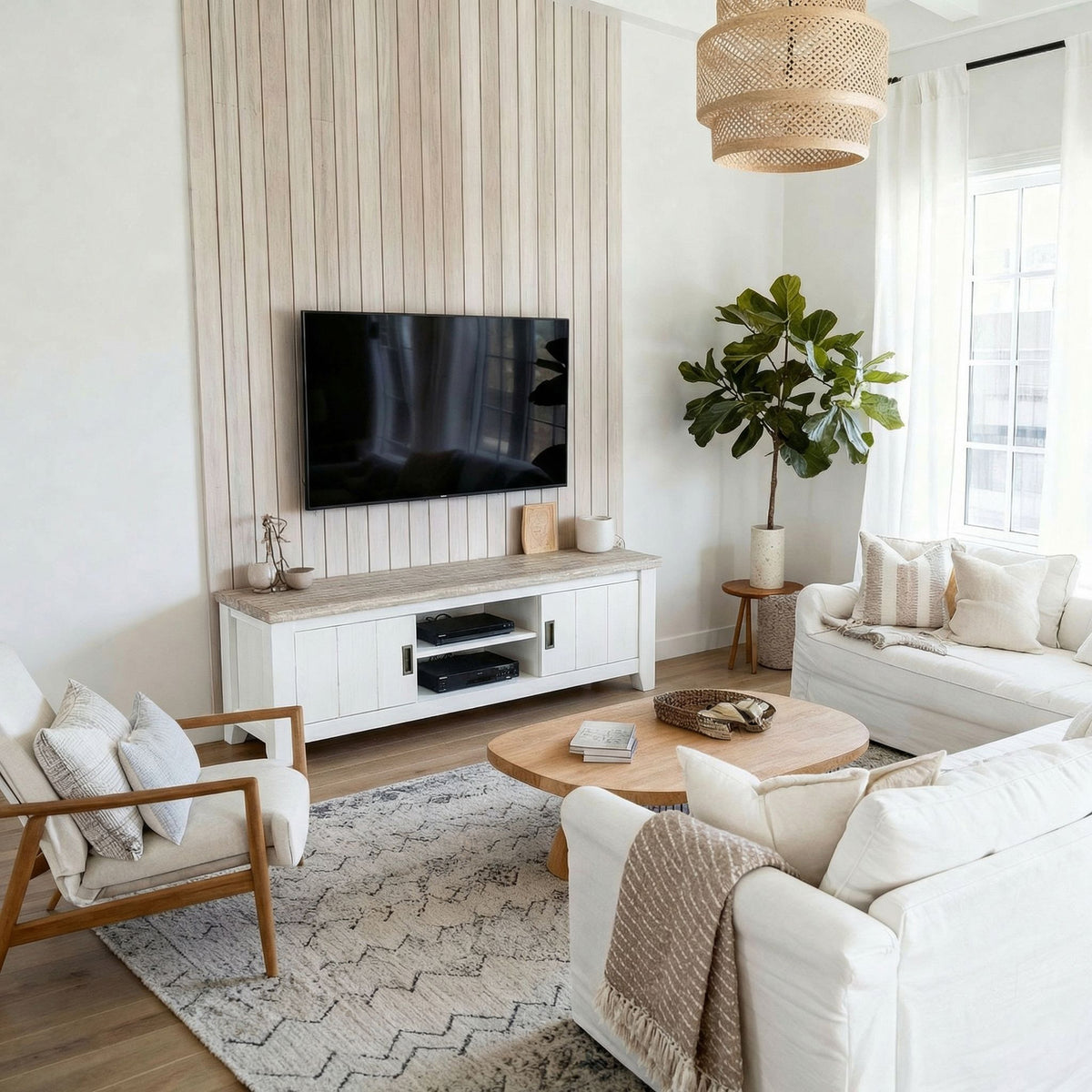 Byron Acacia 2 Door TV Unit below a wall mounted television, in a room with a slatted feature wall and fiddle leaf fig
