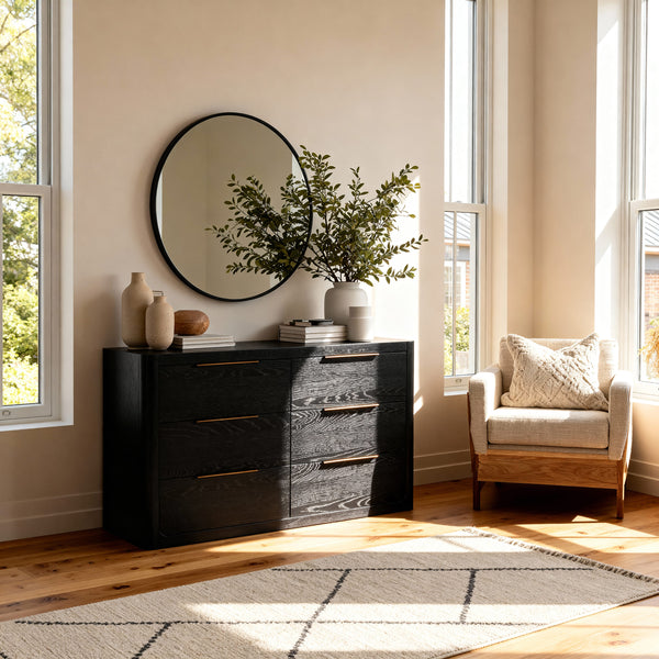 Liverpool Pine 6 Drawer Chest - Black below a round black mirror, topped with olive stems beside an armchair