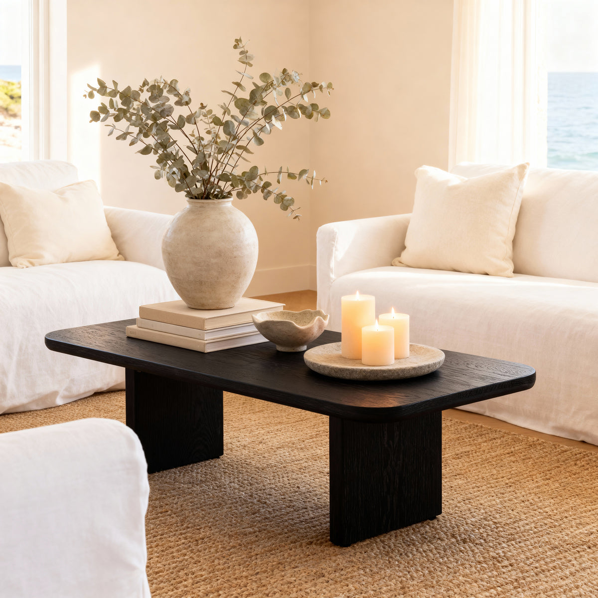 Black coffee table with decorative items in a living room setting

