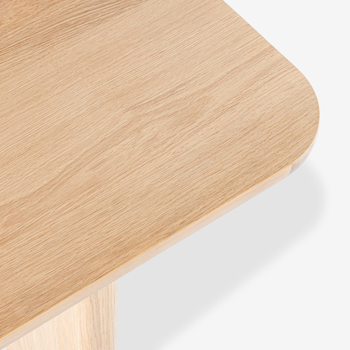 Close-up of a wooden stool with a light finish on a white background

