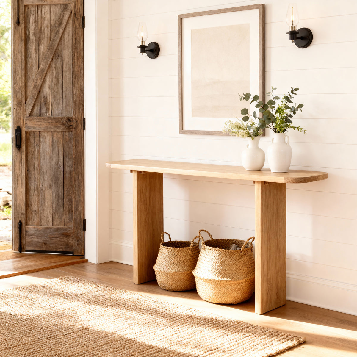 Wooden console table with decorative items in a home entryway.

