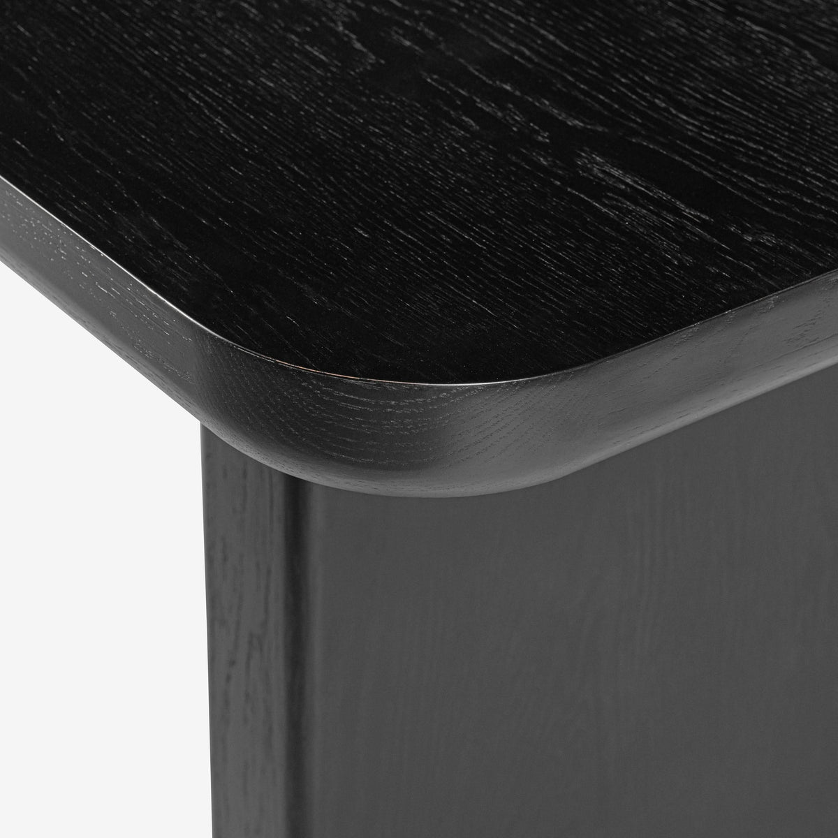 Close-up of a black wooden table corner on a white background

