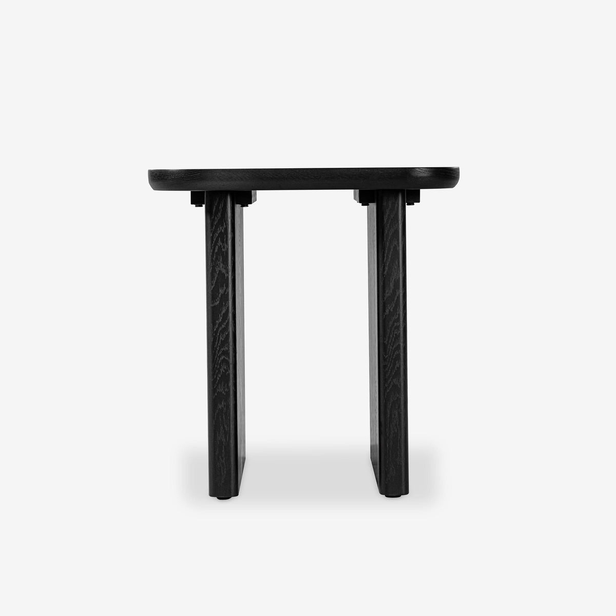 Black table with textured legs on a white background


