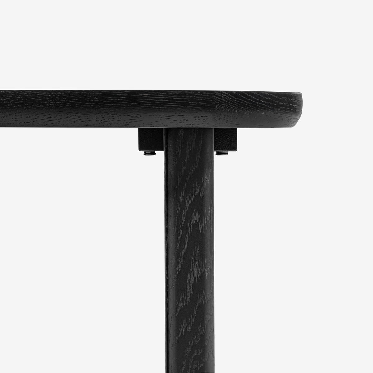 Close-up of a black wooden table leg on a white background

