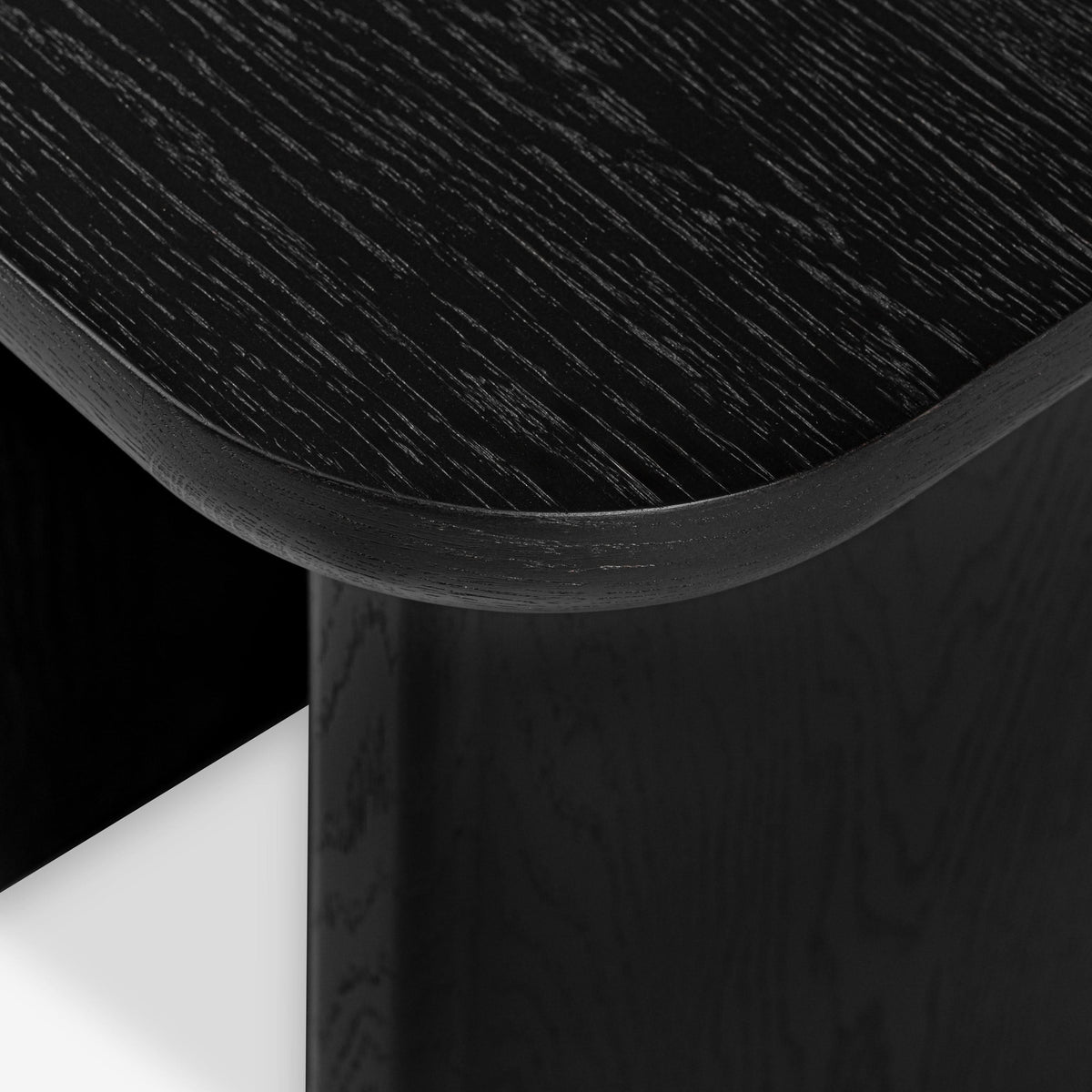 Close-up of a black wooden stool with a white background


