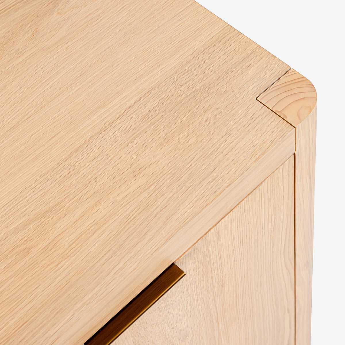 Close-up of a wooden drawer with a light finish on a white background

