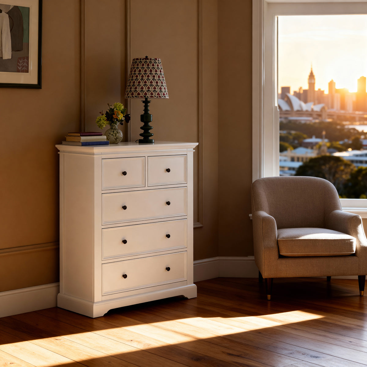 London Pine 5 Drawer Tallboy topped with a patterned lamp in a warm toned room, by a window at sunset