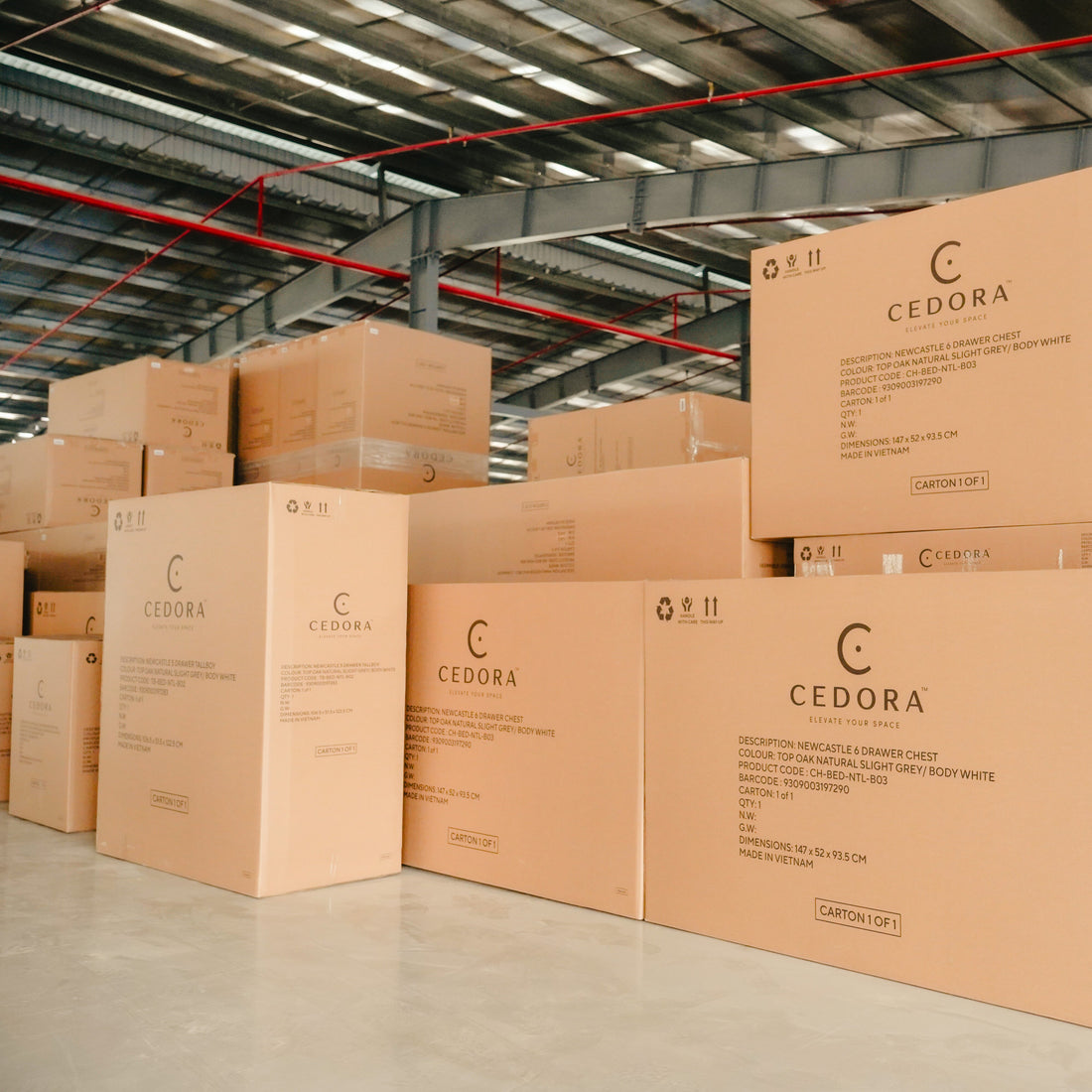Stacks of Cedora branded cardboard boxes in a warehouse setting.