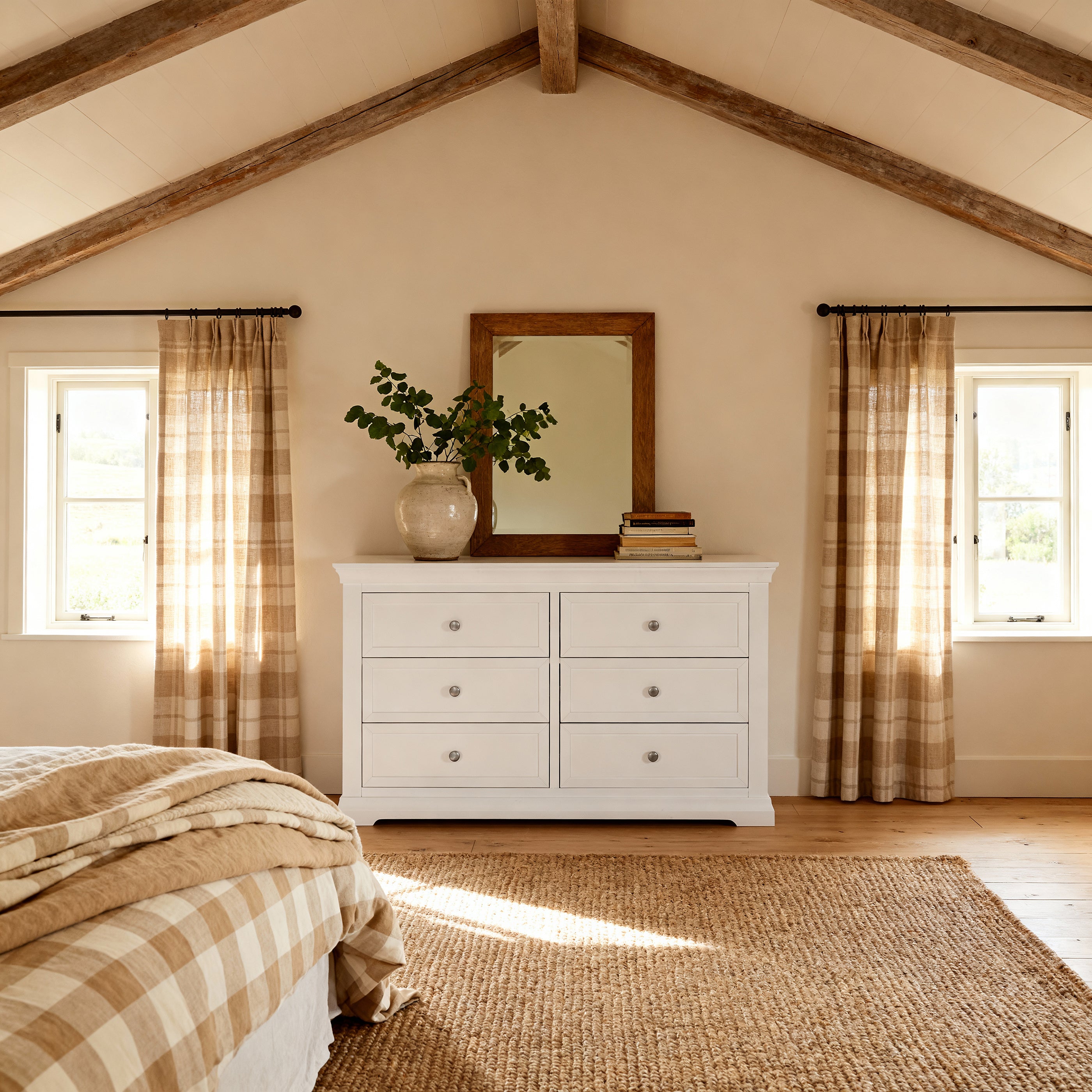 Nestled bedroom with a white dresser, plaid curtains, and wooden beams.

