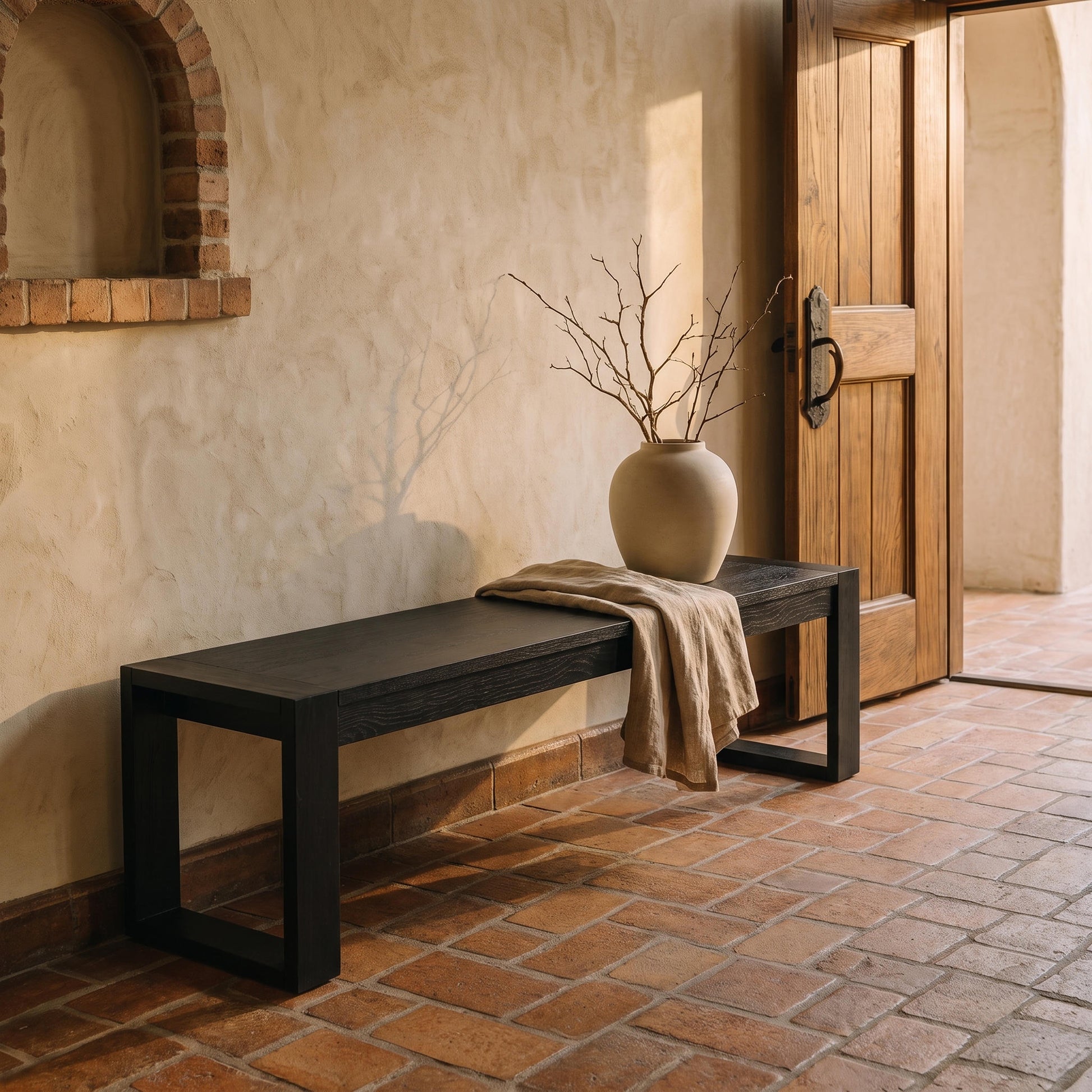 Richmond Pine Dining Bench 150cm - Black against a limewashed wall on terracotta tiles