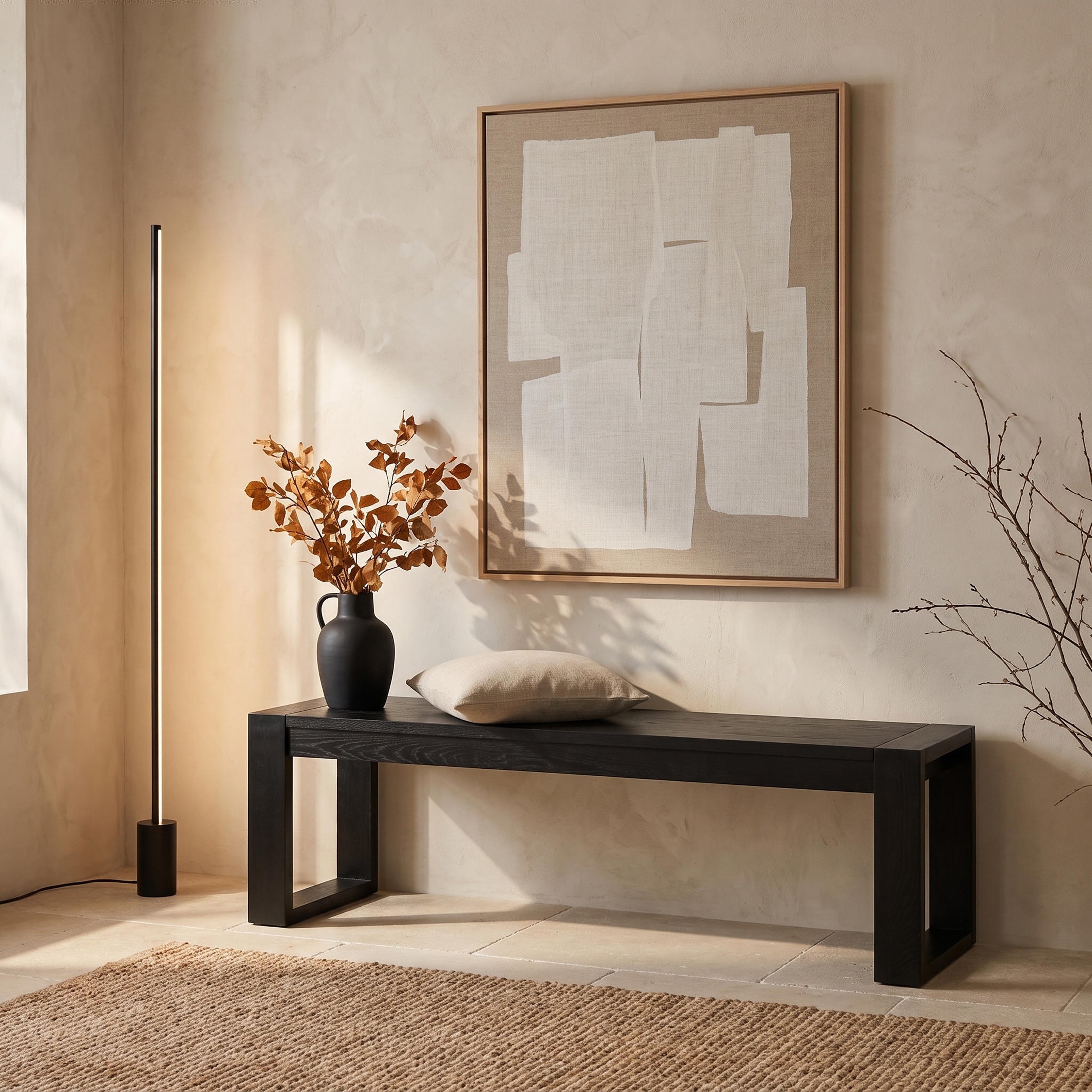 Richmond Pine Dining Bench 150cm - Black below a large abstract canvas, topped with a cushion and a vase of autumn foliage
